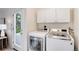 Laundry room with white washer and dryer and exterior access at 2986 S Elm St, Denver, CO 80222