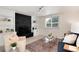 Bright living room featuring a black brick fireplace, plush seating, and a clear glass coffee table at 2986 S Elm St, Denver, CO 80222