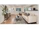 Bright living room features wood floors, neutral paint, modern furnishings and an open floor plan at 2986 S Elm St, Denver, CO 80222
