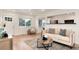 Open-concept living room with stylish decor, wood floors, bright lighting, and comfortable seating at 2986 S Elm St, Denver, CO 80222