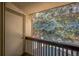 View from the balcony of mature green trees, which provide shade and privacy at 1111 S Garrison St # 202, Lakewood, CO 80232