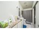 Neutral bathroom features a granite countertop, undermount sink, and shower with a gray patterned curtain at 1111 S Garrison St # 202, Lakewood, CO 80232
