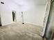 Neutral carpeted bedroom featuring sliding glass doors to a balcony and plenty of open space at 1111 S Garrison St # 202, Lakewood, CO 80232