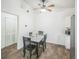 Dining area with wood floors features modern ceiling fan, and a dining table for four at 1111 S Garrison St # 202, Lakewood, CO 80232