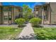 Landscaped walkway between two condo buildings, featuring mature greenery and well-maintained lawns at 1111 S Garrison St # 202, Lakewood, CO 80232