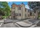 Two-story condo building featuring wood siding, a private entrance, and mature landscaping at 1111 S Garrison St # 202, Lakewood, CO 80232