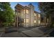 Exterior of a two-story multi-Gathering building with covered patios and large trees at 1111 S Garrison St # 202, Lakewood, CO 80232