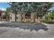 Exterior daytime shot of the multi-Gathering building showing the covered patios and mature trees at 1111 S Garrison St # 202, Lakewood, CO 80232