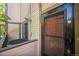 Tan townhouse exterior showing the front door and sliding door to a porch or patio at 1111 S Garrison St # 202, Lakewood, CO 80232