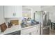 Bright kitchen features white cabinetry, stainless steel appliances, and marble countertops at 1111 S Garrison St # 202, Lakewood, CO 80232