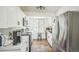 Modern kitchen featuring white cabinetry, stainless steel appliances, and wood-look flooring at 1111 S Garrison St # 202, Lakewood, CO 80232