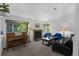 Comfortable living room featuring a brick fireplace, cozy seating, and a piano at 1111 S Garrison St # 202, Lakewood, CO 80232