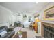 Inviting living room featuring a cozy fireplace, piano, neutral carpet, and natural light at 1111 S Garrison St # 202, Lakewood, CO 80232