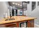 Close-up of a bar area showcasing a unique countertop, a mini-dishwasher, and stylish lighting at 6715 Raritan Dr, Denver, CO 80221