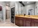 Contemporary bathroom featuring a double vanity, a sleek shower, and convenient washer and dryer at 6715 Raritan Dr, Denver, CO 80221