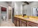 Modern bathroom with double vanity, granite countertops, and a luxurious tiled shower and laundry at 6715 Raritan Dr, Denver, CO 80221
