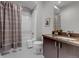 Bathroom features a shower, white subway tiles, and a vanity with dark cabinetry at 6715 Raritan Dr, Denver, CO 80221