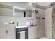 Well-lit bathroom with modern gray tiling, sleek fixtures, and decorative accents in a contemporary style at 6715 Raritan Dr, Denver, CO 80221