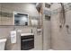 Modern bath with sleek vanity, a glass-enclosed shower and tiled walls at 6715 Raritan Dr, Denver, CO 80221