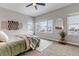Comfortable bedroom with large windows, carpeted floors, and stylish decor at 6715 Raritan Dr, Denver, CO 80221