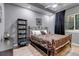 Comfortable bedroom with a decorative metal bed frame and a neutral color palette at 6715 Raritan Dr, Denver, CO 80221