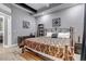 Cozy bedroom featuring a wrought iron bed frame and soft gray walls at 6715 Raritan Dr, Denver, CO 80221