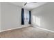 This is a gray bedroom with carpet, window, curtains, and a ceiling fan at 6715 Raritan Dr, Denver, CO 80221