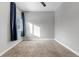 Gray bedroom with carpeted floor, window, blue curtains, and a ceiling fan at 6715 Raritan Dr, Denver, CO 80221