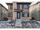 Contemporary two-story home featuring a covered entryway and a vibrant blue front door at 6715 Raritan Dr, Denver, CO 80221