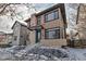 Eye-level view of a modern two-story home with a covered entrance and distinctive blue front door at 6715 Raritan Dr, Denver, CO 80221