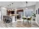 Open-concept kitchen and dining area with a large island, stainless steel appliances, and modern finishes at 6715 Raritan Dr, Denver, CO 80221