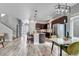 Bright, open-concept living area with wood floors, modern decor, and a view into the dining and kitchen spaces at 6715 Raritan Dr, Denver, CO 80221
