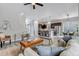 Open-concept living room with hardwood floors, a kitchen island, stainless appliances, and a ceiling fan at 6715 Raritan Dr, Denver, CO 80221