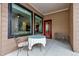 Cozy patio with a glass table, chairs, and a decorative bicycle at 6715 Raritan Dr, Denver, CO 80221