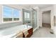 Bright bathroom featuring a soaking tub and a separate glass shower at 4666 S Malaya Ct, Aurora, CO 80015