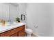 Powder room with white walls, wood cabinet, framed art, and sink at 4666 S Malaya Ct, Aurora, CO 80015