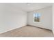 Carpeted bedroom with neutral walls and a window at 4666 S Malaya Ct, Aurora, CO 80015
