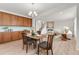 Dining area featuring a modern chandelier, a kitchen and open-concept living room at 4666 S Malaya Ct, Aurora, CO 80015