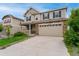 Charming two-story home featuring a stone facade, attached two car garage, and manicured front yard at 4666 S Malaya Ct, Aurora, CO 80015