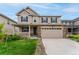 Charming two-story home featuring a stone facade, attached two car garage, and manicured front yard at 4666 S Malaya Ct, Aurora, CO 80015