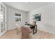 Bright home office with french doors, light wood floors, a modern desk and ample natural light at 4666 S Malaya Ct, Aurora, CO 80015