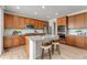 Bright kitchen features a central island, stainless steel appliances, and light wood floors at 4666 S Malaya Ct, Aurora, CO 80015