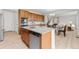 Kitchen with island and stainless appliances opens to a dining area and living room at 4666 S Malaya Ct, Aurora, CO 80015