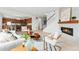 Open-concept living area featuring a fireplace and flowing into the dining area and kitchen at 4666 S Malaya Ct, Aurora, CO 80015