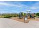 Community playground with slides and green trees in a sunny environment at 4666 S Malaya Ct, Aurora, CO 80015