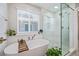 Spa-like bathroom featuring a freestanding tub, a glass-enclosed shower, and modern fixtures at 12510 Fisher St, Englewood, CO 80112