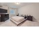 Cozy bedroom featuring a bed with decorative pillows, two nightstands, and a dresser at 12510 Fisher St, Englewood, CO 80112