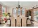 An elegant dining room with seating for six, an ornate chandelier, and a beautiful wine cabinet at 12510 Fisher St, Englewood, CO 80112