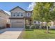 Charming two-story home with a manicured lawn, inviting front porch, and a two car garage at 12510 Fisher St, Englewood, CO 80112