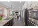 Kitchen featuring stainless appliances, granite countertops and an open concept layout to the Gathering room at 12510 Fisher St, Englewood, CO 80112